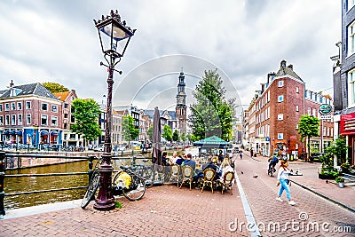 Typical scene of a gathering of tourists and locals at a cafe at the Prinsengracht in Amsterdam Editorial Stock Photo