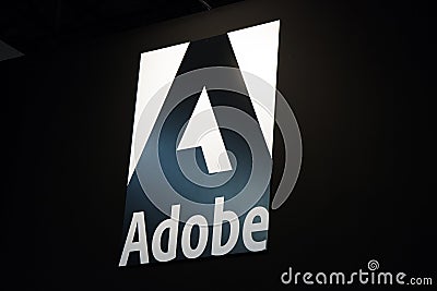 Adobe logo and letters on a black wall Editorial Stock Photo