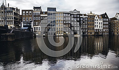 AMSTERDAM,NETHERLANDS - SEPTEMBER 06, 2018: Sunset in Amsterdam.Bicycle parking and traditional old dutch buildings.Flower market Editorial Stock Photo