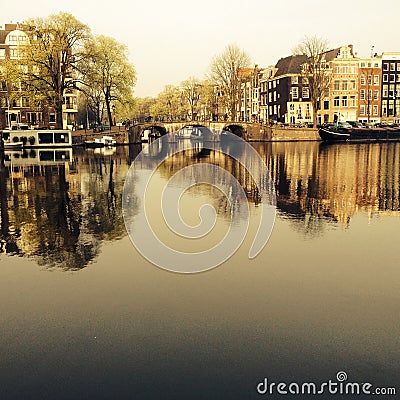 Amsterdam/THE NETHERLANDS: A typical view of the Amstel canal with old mansions in the center of Amsterdam, the N Editorial Stock Photo