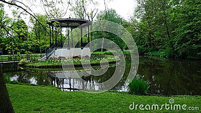 Amsterdam park with a lake, flowers grow around the gazebo Stock Photo