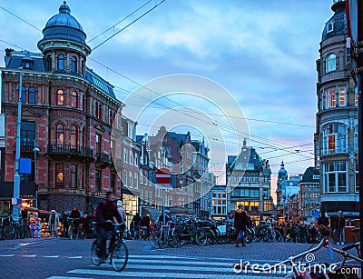 Amsterdam`s city life near the Singel canal view from Koningsplein bridge in the dusk, Netherlands Editorial Stock Photo