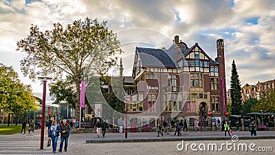 Amsterdam streets with people walking and Moco museum Editorial Stock Photo