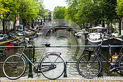 Amsterdam summer 2020, the view of a canal with bicycle Editorial Stock Photo