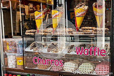 An Amsterdam sweet shop window, with waffles and churros available to buy. Editorial Stock Photo
