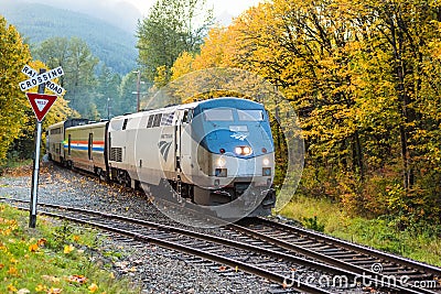 Amtrak Empire Builder in the Fall passing through the Cascade Mountains heading eastbound Editorial Stock Photo