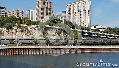 Amtrak train travels along river at St. Paul, Minnesota Editorial Stock Photo