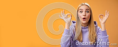 Amused talented creative young blond female tell excellent idea show okay no problem gesture persuade friends everything Stock Photo