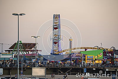 Amusement park with ferris wheel and rollercoaster at Santa Monica pier beach Editorial Stock Photo