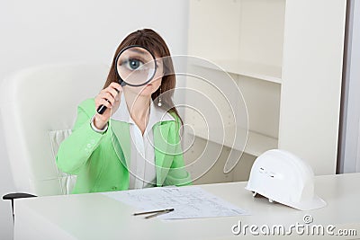 Amusing girl looks at us through big magnifier Stock Photo