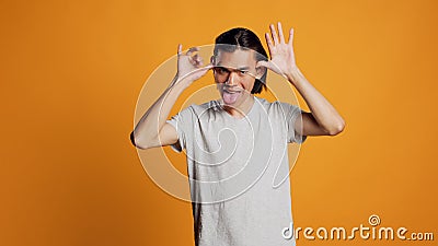Amusing guy sticking tongue out and acting funny Stock Photo