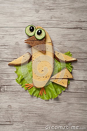 Amusing sandwich bird made on wooden background Stock Photo