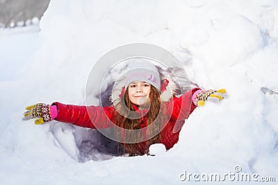 Amusing smiling girl in the winter at a snow cave Stock Photo