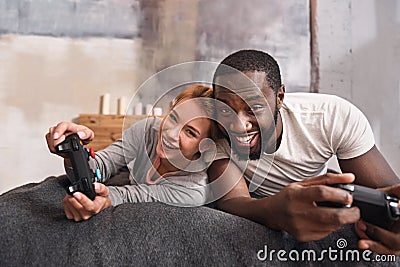 Amusing young international couple playing games at home Stock Photo