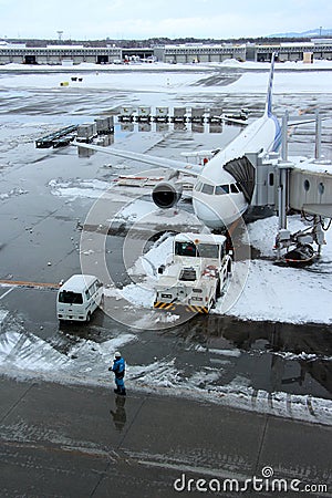 ANA flight loading at Chitose airport on a snowy day Sapporo Editorial Stock Photo