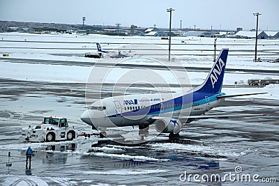 ANA Taxing at Chitose airport on a snowy day Sapporo Editorial Stock Photo