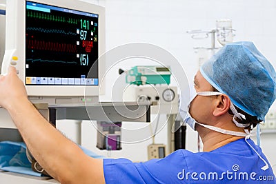 Anaesthesiologist at monitor in operation room Stock Photo