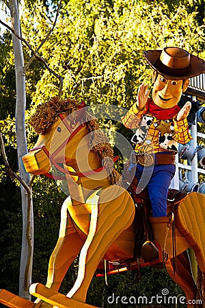 Woody from Toy Story is riding on a rocking horse on a float in Disneyland Editorial Stock Photo