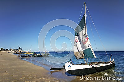 Anakao, Madagascar - May 03, 2019: Fisherman piroga small fishing boat with sail waiting at the coast on sunny day, more ships Editorial Stock Photo