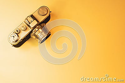 Analog camera on yellow background. copy space Stock Photo