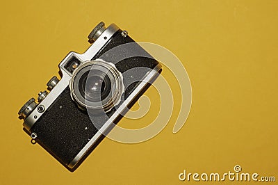 Analog camera on yellow background. copy space Stock Photo