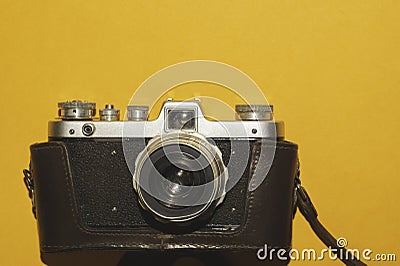 Analog camera on yellow background. copy space Stock Photo