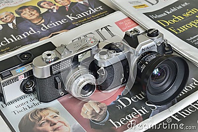 Analog cameras on newspapers Editorial Stock Photo