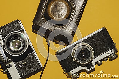 Analog cameras on yellow background. copy space Stock Photo