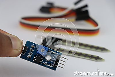 Analog to digital signal converter for soil moisture detection sensor with sensor and wires on the background Stock Photo