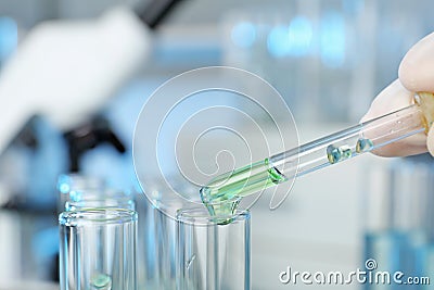 Analyst dripping reagent into test tube Stock Photo