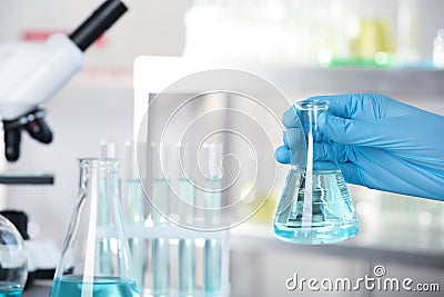 Analyst holding flask with fluid in laborator Stock Photo