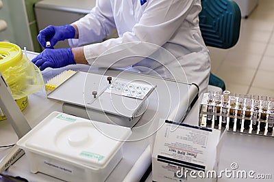 Analyst prepares blood plasma samples for RPR test Editorial Stock Photo