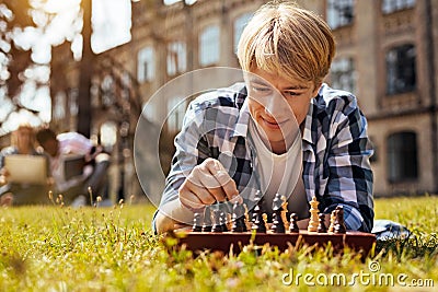 Analytical intelligent man relaxing while playing Stock Photo