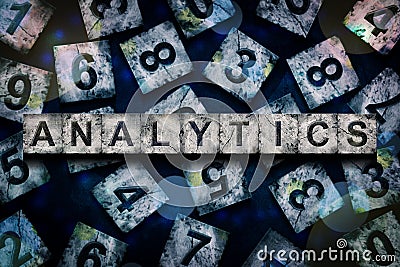 Analytics, words, above different numbers, on a dark blue background, with different letters. Alphabet on stone blocks Stock Photo