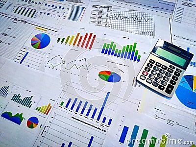 analyzing income charts and graphs with calculator. Close up. Business financial analysis and strategy concept. Stock Photo