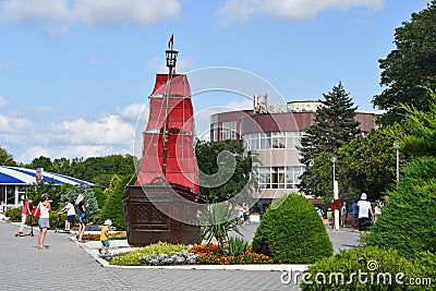 Anapa, Russia, July, 18, 2018. People walking on the promenade next to the sailboat `Scarlet sails` on Anapa resort in sunny day Editorial Stock Photo