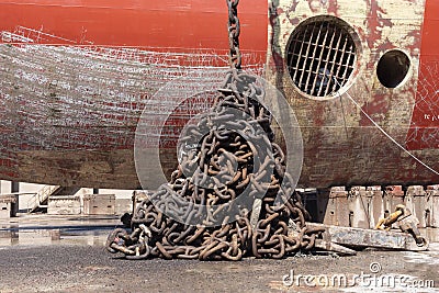 Anchor chain collected near ships hull. Stock Photo
