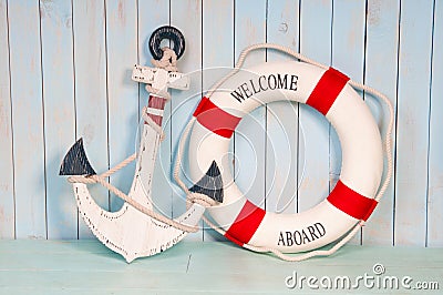 Anchor and life buoy on a background of white shabby wall boards Stock Photo