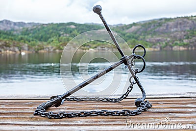 An anchor near the sea in the fjord of Bergen in Norway - 1 Stock Photo