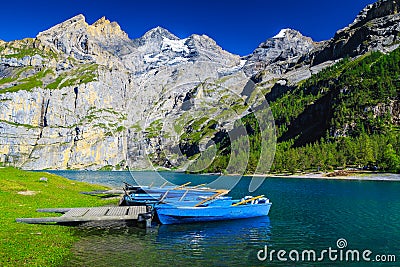 Anchored boats on the lake Oeschinensee, Bernese Oberland, Switzerland Stock Photo