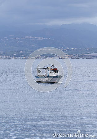 an anchored small white boat in middle of milazzo bay with sicilian mountains Editorial Stock Photo