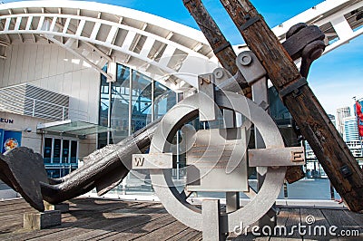 Ancient anchor and compass symbol as monument at the entrance of Australian National Maritime Museum, Darling Harbour, NSW. Editorial Stock Photo