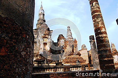 Ancient antiquity architecture and antique ruins building for thai people travelers travel visit respect praying at Si Satchanalai Stock Photo