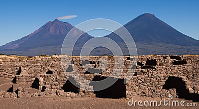 ancient archeology of stone houses with a volcano in the background in high resolution Stock Photo