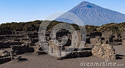 ancient archeology of stone houses with a volcano in the background in high resolution and sharpness Stock Photo