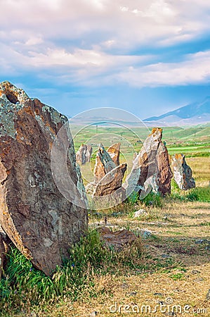 The ancient astrologica observatory Karahunj in Armenia. `Armenian Stonehenge`. A view of the horizon and a blue bright sky. Stock Photo