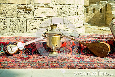 Ancient azerbaijani musical instruments tar and saz with old vintage azeri tea pot for boiling water Stock Photo