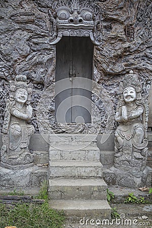 Ancient balinese door closed with sculptures Stock Photo