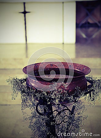 Ancient baptismal font in copper Stock Photo