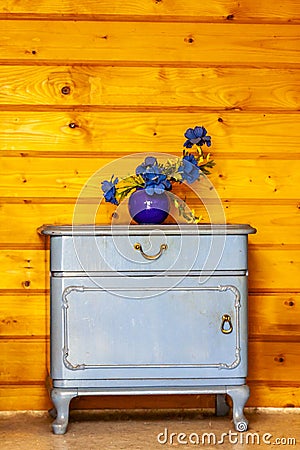 Ancient blue drawers placed in front of wooden wall Stock Photo